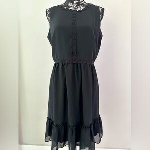 Sleeveless black dress with floral appliqué